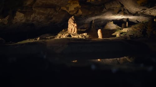 Beleuchteter Tropfsteinhöhlen aus dunklem Felsstein mit Stalaktiten-Hintergrund