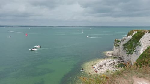 Boats Sailing In The Ocean Next To The Old Harry Rocks At Handfast Point, on the Isle of Purbeck in