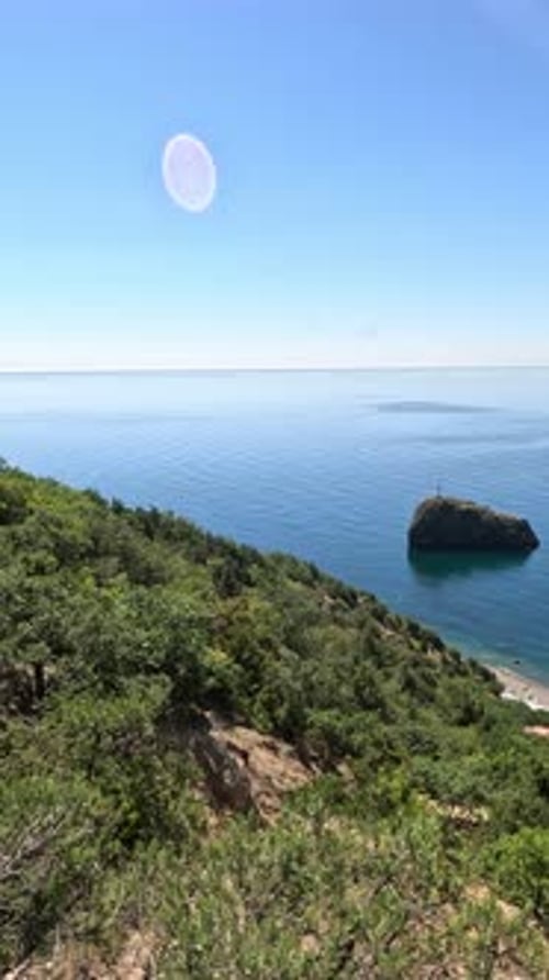 Aerial View on Calm Azure Sea and Volcanic Rocky Shores Small Waves on Water Surface in Motion Blur
