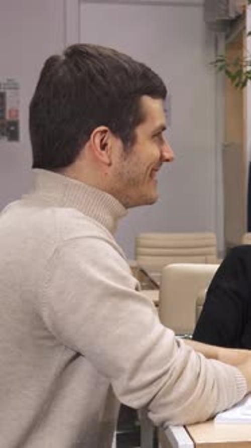 Engaging Young Man Passionately Explains Ideas to His Female Coworkers