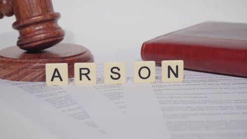 Gavel and Arson Block Lettering on Document