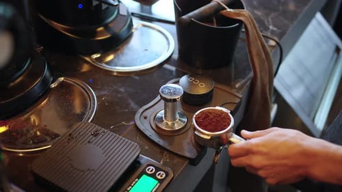 4K Barista making hot coffee on coffee maker at coffee shop.