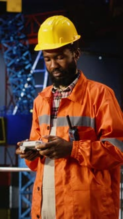 Vertical Video Engineer Operates a UAV at a Safe Distance From an Offshore Drilling Rig