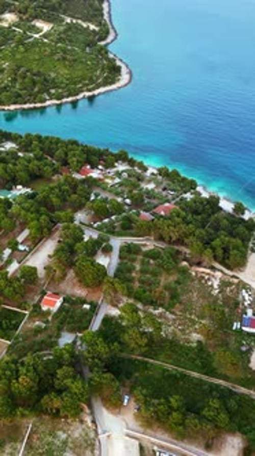 Aerial, drone view of buildings on the shore of the Adriatic sea in Croatia. Vertical