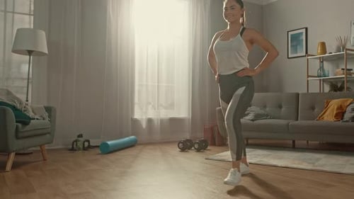 Shapely and Beautiful Athletic Fitness Girl in Sportswear is Doing Forward Lunge Exercises in Her S