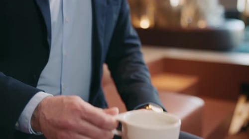 Man Drinking Coffee in Modern Workplace Environment