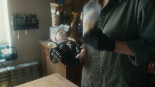 Anonymous Craftswoman Shaking Spray Adhesive for Gluing New Upholstery