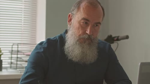 Old Man Working in Office