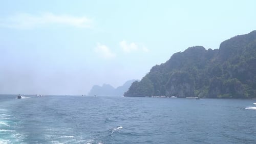 Speed boat driving tourists on to a day trip, koh phi phi, thailand