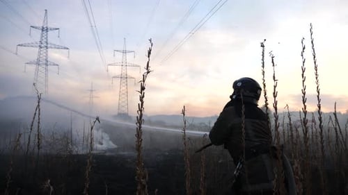 Firefighter Extinguishes Brush Fire at Sunset