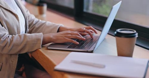 Woman, coffee shop and typing on laptop, hands and remote work for business