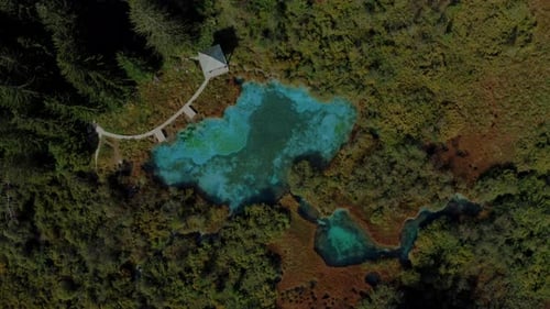 Aerial view of a beautiful nature reserve in the mountains. The colour of a lake is bright blue.