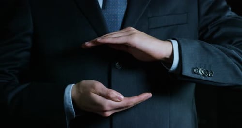 Person In Business Suit Presenting An Item
