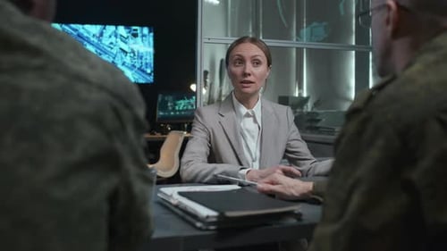 Woman Briefing Military Personnel in Office Setting