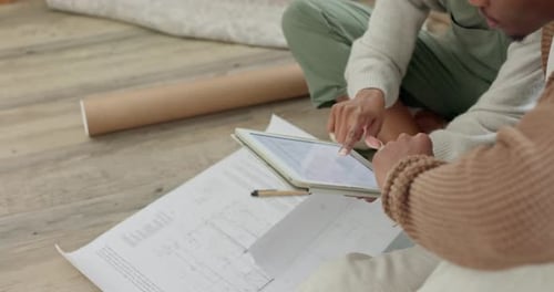 Couple Working on Tablet in New Home
