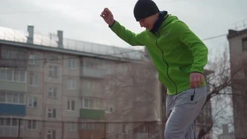 Young Man Playing with Soccer Ball Outdoors in City