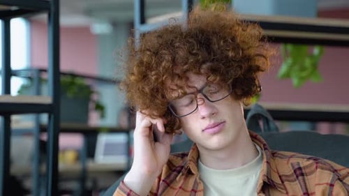 Young Adult with Curly Red Hair Indoors