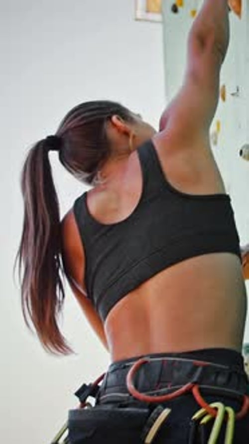 Close Up Shot of Young Woman Climber Going Up on Outdoor Rocky Wall