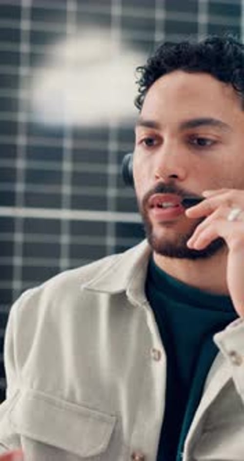Man, talk and headset with solar panel at call centre for consultation, customer service