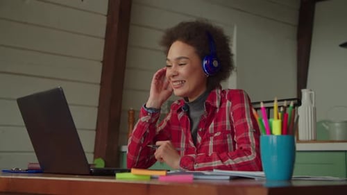 Woman Talking into Laptop in Home Office