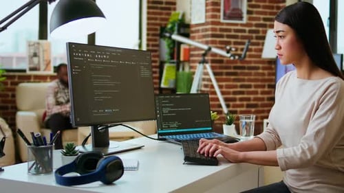 Professional Software Developer Types Code on a Laptop in a Sleek Workspace