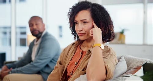 Contemplative Woman on Couch in a Home Setting
