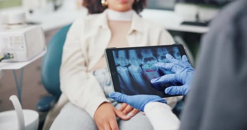 Dentist Shows Dental X-Rays to Patient on Tablet