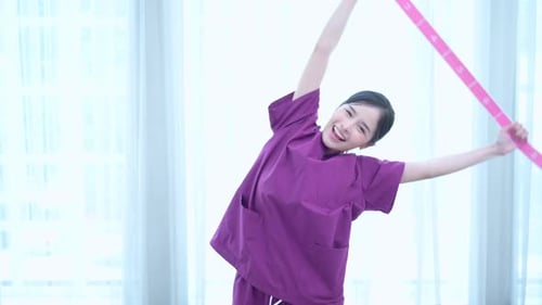 Young Woman Leads Seniors in Light Exercise Class