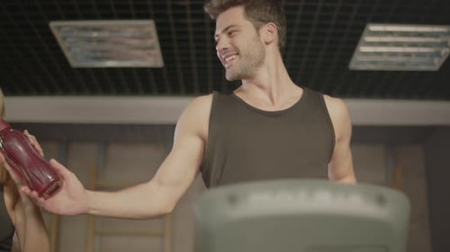 Man and Woman Running on Treadmills, Gym Interior