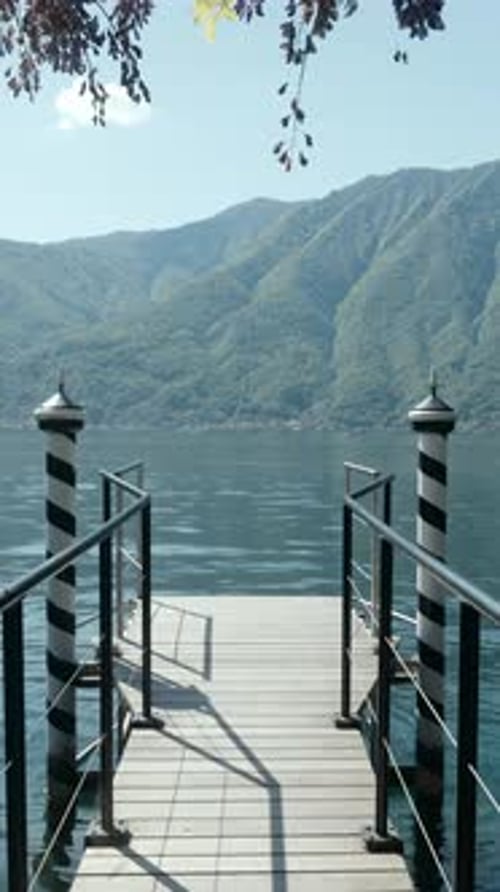 A Scenic Dock That Beautifully Overlooks a Serene and Picturesque Mountain Lake View Action