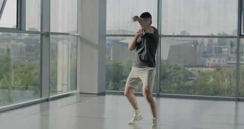 Full Body Portrait of Active Young Sportsman Boxing Alone Shadow Fighting Working Out in Modern Gym