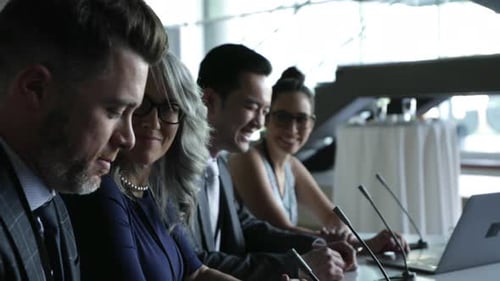 Business Panel Discussing Issues at a Conference