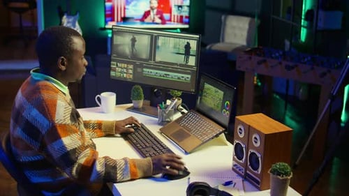 Adult Editing Video on Computer at Home