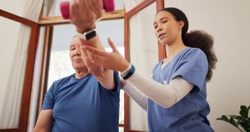 Senior Man Lifting Weights with Healthcare Provider