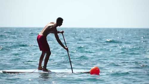 Man Sup Sea Strong Athletic Man Learns to Paddle Sup Standing on Board in Open Sea Ocean on Sunny