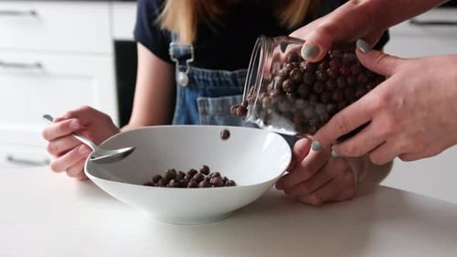Child Waits for Cereal to be Poured