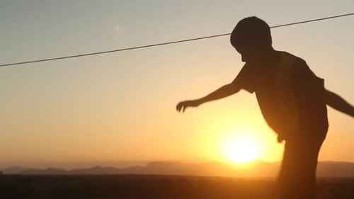Silhouette of children playing in the way back from school