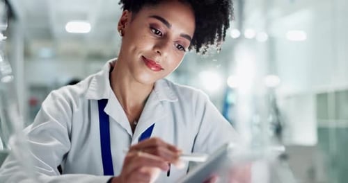Female Scientist Working on Tablet in Modern Lab