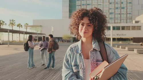 Smiling Student with Books on University Campus