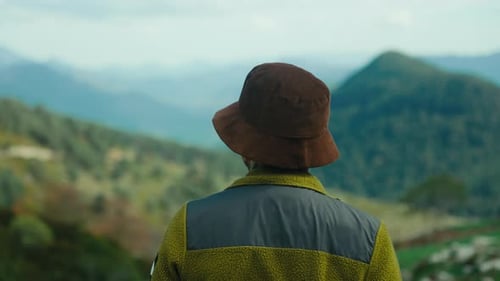 Male Traveler on Inspiring Mountain Scenery