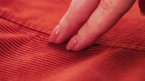 Hand Touches Soft Orange Corduroy Fabric