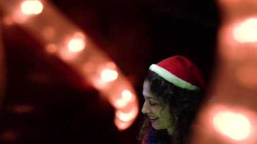 Smiling Woman Wearing Santa Hat at Christmas