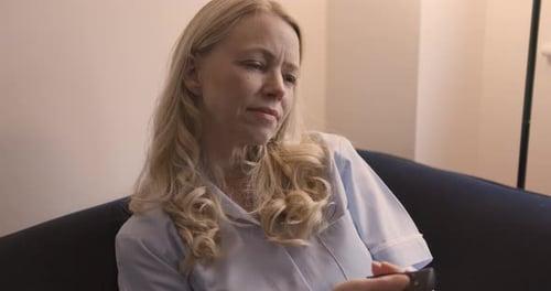 Woman Relaxing on Couch with Remote