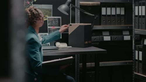 Focused Investigator Working in Dark Office