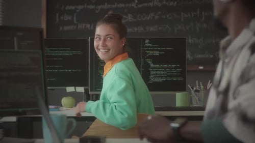 Female Programmer Chatting with Colleague during Office Workday