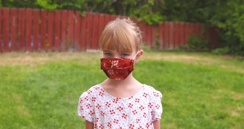 Blonde Child Wearing Face Mask Outdoors