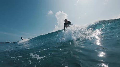 Surfer rides the ocean wave in the Maldives