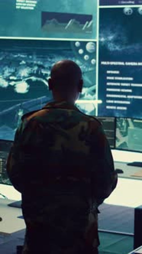 Man Works with Computers in Dimly Lit Room