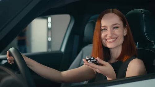 Woman Holding Car Keys in Driver's Seat