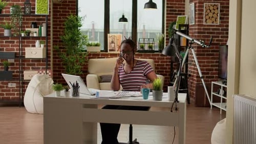 Woman Working at Home Office Talking on Phone